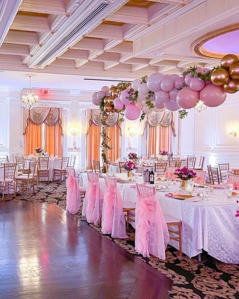 Elegant Sweet 16 party decor with balloons and flowers