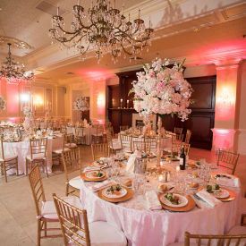 pink uplighting in gable ballroom with floral center pieces